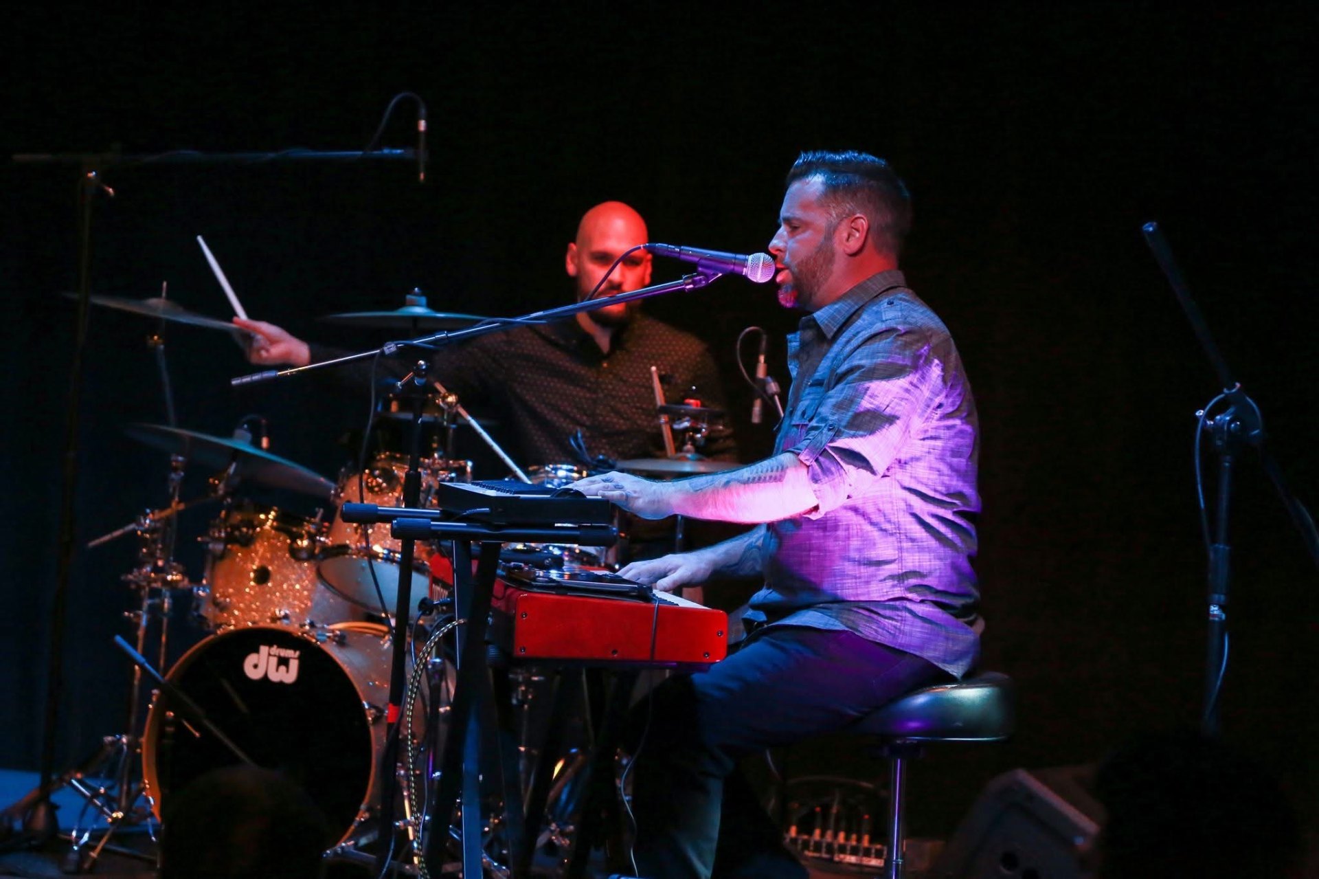 Dan Signor at the piano with drummer on stage