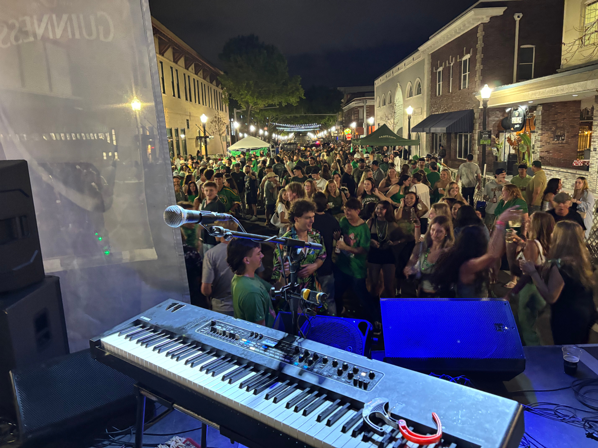Huge street crowd watching Dan Signor perform at night