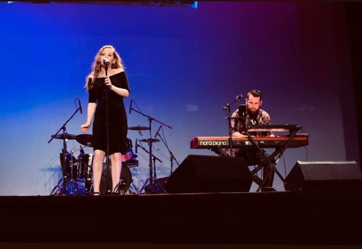 Dan on Nord piano accompanying a vocalist on stage
